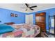 Comfortable main bedroom with a large bed, a ceiling fan, and rich blue walls at 2411 Heritage Park Nw Cir # 14, Kennesaw, GA 30144