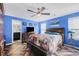 A spacious main bedroom with blue walls, a ceiling fan, and herringbone wood floors at 2411 Heritage Park Nw Cir # 14, Kennesaw, GA 30144