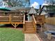 Inviting backyard deck with outdoor bar, seating, stairs to the yard and manicured landscaping at 1670 Rogers Sw Ave, Atlanta, GA 30310