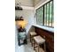 Indoor bar area with wood paneling, marble countertop, bar stools, and wine rack at 1670 Rogers Sw Ave, Atlanta, GA 30310