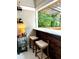 Indoor bar area with wood paneling, marble countertop, bar stools, and wine rack at 1670 Rogers Sw Ave, Atlanta, GA 30310