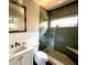 A contemporary bathroom featuring a glass-enclosed shower and marble countertop sink at 1670 Rogers Sw Ave, Atlanta, GA 30310
