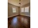 Bedroom with hardwood floors, two windows letting in natural light, and classic trim at 1670 Rogers Sw Ave, Atlanta, GA 30310