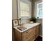 Well lit kitchen counter with white granite countertops and natural wood cabinets at 1670 Rogers Sw Ave, Atlanta, GA 30310