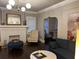 Cozy living room with a fireplace, comfortable seating, and seamless flow to the dining area at 1670 Rogers Sw Ave, Atlanta, GA 30310