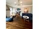 Open-concept living room featuring hardwood floors, a fireplace, and an open view to the dining and kitchen areas at 1670 Rogers Sw Ave, Atlanta, GA 30310