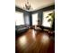 Spacious room with hardwood floors, natural light, couch, desk and decorative tree at 1670 Rogers Sw Ave, Atlanta, GA 30310