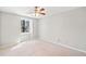 Neutral bedroom with carpet flooring, ceiling fan, and ample natural light at 195 Sailwind Ct, Roswell, GA 30076