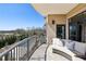 Inviting balcony with a comfortable couch overlooking a pool and wooded landscape at 2700 Paces Ferry Se Rd # 302, Atlanta, GA 30339