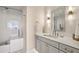 Elegant bathroom featuring a gray vanity with marble countertop and bright lighting at 2700 Paces Ferry Se Rd # 302, Atlanta, GA 30339