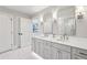 Stylish bathroom featuring double vanity sinks, modern fixtures, and marble floors at 2700 Paces Ferry Se Rd # 302, Atlanta, GA 30339