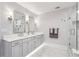 Bright bathroom with marble floors, double vanity sinks, and a glass-enclosed shower at 2700 Paces Ferry Se Rd # 302, Atlanta, GA 30339