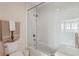 Bathroom featuring a glass-enclosed tub and shower with tiled walls at 2700 Paces Ferry Se Rd # 302, Atlanta, GA 30339