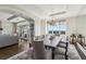Open-concept dining area with hardwood floors, modern lighting, and seamless flow to living area at 2700 Paces Ferry Se Rd # 302, Atlanta, GA 30339