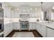 Well-lit kitchen boasting white cabinets, stainless steel appliances, and a cozy rug at 2700 Paces Ferry Se Rd # 302, Atlanta, GA 30339