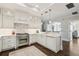 Kitchen featuring white cabinets, marble countertops, stainless steel appliances and modern lighting at 2700 Paces Ferry Se Rd # 302, Atlanta, GA 30339
