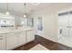 Kitchen area with an island and sink, complemented by modern appliances and access to the laundry room at 2700 Paces Ferry Se Rd # 302, Atlanta, GA 30339