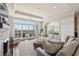 Large living room with a stone fireplace, sliding doors to a balcony, and open views to the dining room at 2700 Paces Ferry Se Rd # 302, Atlanta, GA 30339