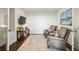 Cozy living room featuring hardwood floors, two leather chairs, a TV, and a decorative rug at 2700 Paces Ferry Se Rd # 302, Atlanta, GA 30339