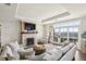 Cozy living room with a stone fireplace, large windows with city views, and comfortable seating at 2700 Paces Ferry Se Rd # 302, Atlanta, GA 30339
