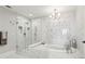 Spa-like bathroom featuring marble countertops, a soaking tub, and a glass-enclosed shower at 2700 Paces Ferry Se Rd # 302, Atlanta, GA 30339