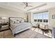 Inviting bedroom with hardwood floors, a ceiling fan, tray ceilings and a large window with a view at 2700 Paces Ferry Se Rd # 302, Atlanta, GA 30339
