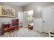 Spacious playroom with a patterned rug, dollhouse, doorway, and white wainscoting at 2734 Skyland Ne Dr, Brookhaven, GA 30319