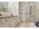 Bathroom with a modern vanity, dual sinks, a large mirror, and a glass shower, designed for relaxation and efficiency at 3820 Roswell Ne Rd # 317, Atlanta, GA 30342