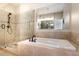 Bathroom with a shower and soaking tub, enhanced with neutral tile, and glass enclosure, offering style and comfort at 3820 Roswell Ne Rd # 317, Atlanta, GA 30342