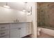 Bathroom with white vanity, granite countertops, and a glass-enclosed shower over a tub, offering comfort and style at 3820 Roswell Ne Rd # 317, Atlanta, GA 30342