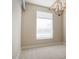 Bright bedroom featuring neutral decor, a large window, and an elegant chandelier at 3820 Roswell Ne Rd # 317, Atlanta, GA 30342