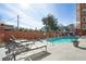 Community pool area with lounge chairs and a brick wall offers a relaxing outdoor retreat for residents at 3820 Roswell Ne Rd # 317, Atlanta, GA 30342
