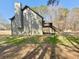 Rear exterior view of home, featuring a spacious yard, a deck, and an outbuilding at 5011 Cliff Top Dr, Loganville, GA 30052