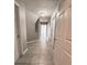 Inviting hallway with tiled floors and neutral paint, leading to other rooms at 5011 Cliff Top Dr, Loganville, GA 30052