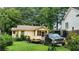 Charming single-story house featuring a screened-in porch, a truck and trailer in the driveway at 514 Glendale Rd, Scottdale, GA 30079