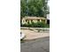 A yellow house is on a lot with a driveway and short stone wall at 514 Glendale Rd, Scottdale, GA 30079
