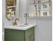 Bathroom vanity featuring marble countertop, stylish fixtures, and an olive green cabinet at 965 Carr Nw St, Atlanta, GA 30318