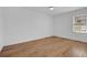 Bright bedroom with hardwood floors, white walls, and natural light from a window at 965 Carr Nw St, Atlanta, GA 30318