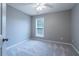 This bedroom has neutral paint, carpet and a bright window at 271 Balaban Cir, Woodstock, GA 30188