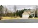 Inviting exterior of a home featuring a two-car garage, manicured lawn, and colorful landscaping at 271 Balaban Cir, Woodstock, GA 30188