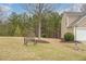 Well-manicured front yard features a bench under a large shade tree near the home's two-car garage at 271 Balaban Cir, Woodstock, GA 30188