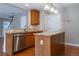 Modern kitchen island with sink, stainless steel dishwasher, and bar seating at 271 Balaban Cir, Woodstock, GA 30188