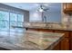 Kitchen island features granite countertops, sink and view into living room at 271 Balaban Cir, Woodstock, GA 30188