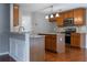 Kitchen with stainless steel appliances, island, and wooden cabinets at 271 Balaban Cir, Woodstock, GA 30188