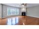 Spacious living room featuring gleaming hardwood floors, a cozy fireplace, and abundant natural light at 271 Balaban Cir, Woodstock, GA 30188