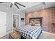 Bedroom with exposed brick wall, a checkered comforter, and a full bathroom off to the left at 285 Centennial Olympic Park Dr # 1705, Atlanta, GA 30313