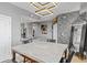 Modern dining room featuring a stone table, stylish light fixture, and decorative stone wall at 285 Centennial Olympic Park Dr # 1705, Atlanta, GA 30313