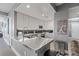 Modern kitchen with stainless steel countertops and white cabinetry, adjacent to entryway at 285 Centennial Olympic Park Dr # 1705, Atlanta, GA 30313