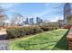 Green outdoor area featuring manicured hedges, turf, accent lighting, and views of the city skyline at 285 Centennial Olympic Park Dr # 1705, Atlanta, GA 30313