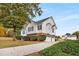 Exterior view featuring a side entrance with garage access and a well-maintained lawn at 5077 Fieldview Dr, Douglasville, GA 30135